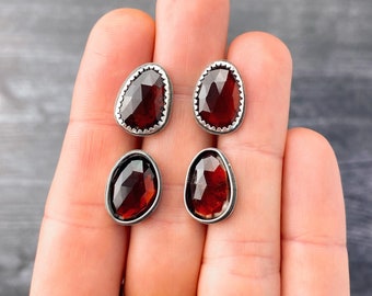 Small garnet studs in sterling and fine silver | Sterling silver earrings with faceted red garnets | Choose smooth or serrated setting