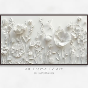 May include: White floral relief art in a dark brown frame. The artwork features sculpted flowers and foliage. The text "4K Frame TV Art" and pixel dimensions are visible at the bottom of the image.