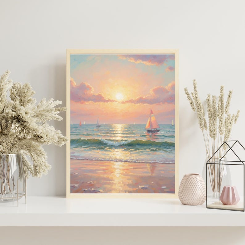 May include: A framed painting of a sunset over the ocean. The sky is filled with pink and orange hues, with the sun setting over the water. Several sailboats are visible on the water, and the waves are gently rolling onto the shore. The painting is displayed on a white shelf.