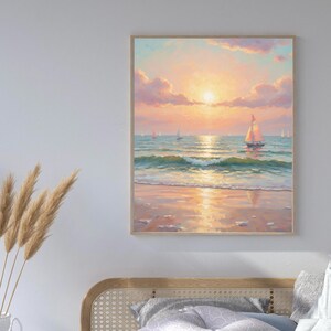 May include: A framed painting depicts a serene beach scene at sunset. The artwork features a sailboat on the water, with the sun setting over the ocean. The sky is filled with pink and orange hues, and the water reflects the sunlight.
