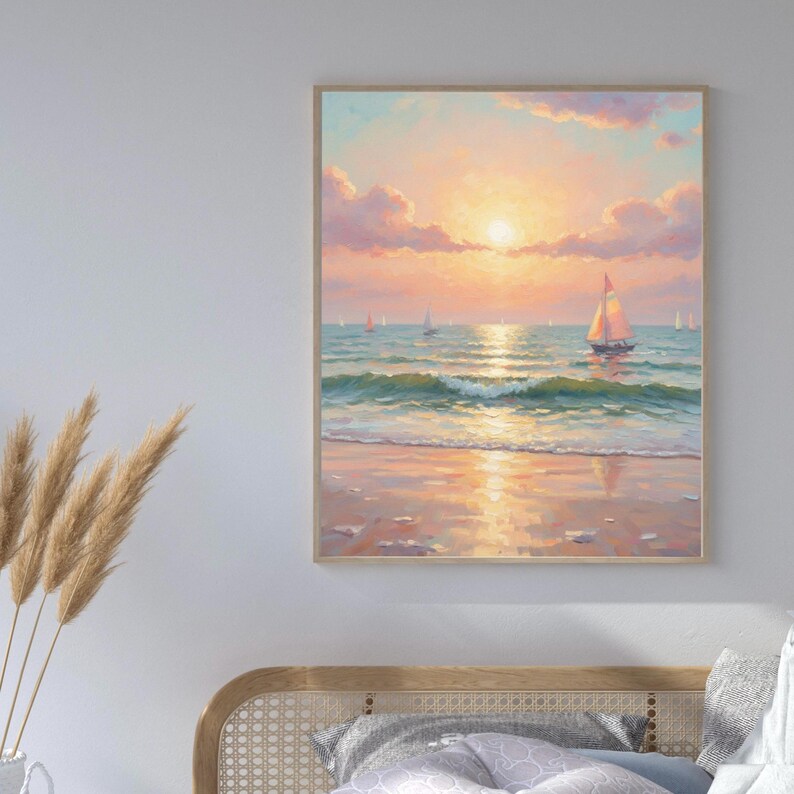 May include: A framed painting depicts a serene beach scene at sunset. The artwork features a sailboat on the water, with the sun setting over the ocean. The sky is filled with pink and orange hues, and the water reflects the sunlight.
