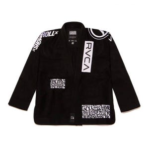 May include: A black martial arts gi jacket featuring white graphic patches and text. The left chest displays the text RVCA in a vertical white rectangle. The right shoulder features the text SHOYOROLL, and the lower front has graffiti-style patches.