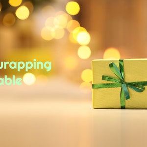 May include: A yellow gift box with a green ribbon and bow. The text "Gift wrapping available" is in the background.