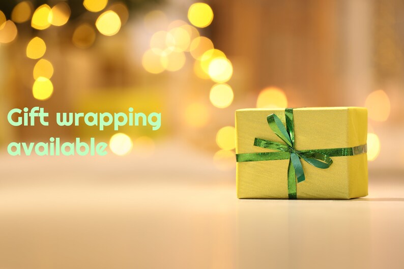 May include: A yellow gift box with a green ribbon and bow. The text "Gift wrapping available" is in the background.