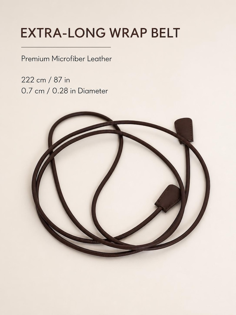 May include: An extra-long wrap belt made of premium microfiber leather. The dark brown cord measures 87 inches in length and 0.28 inches in diameter, featuring two flat, rectangular end pieces. The text reads: EXTRA-LONG WRAP BELT, Premium Microfiber Leather, 222 cm / 87 in, 0.7 cm / 0.28 in Diameter.