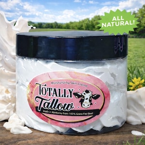 May include: A clear plastic jar filled with white moisturizing skin creme, topped with a black lid. The oval label features the text "Totally Tallow," "Moisturizing Skin Creme," and "Made in Kentucky from 100% Grass Fed Beef" with a cow illustration.