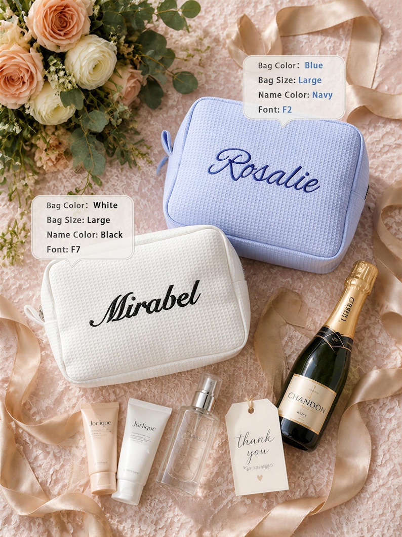 May include: Two large rectangular zippered pouches with a textured waffle pattern. One pouch is light blue with the name Rosalie embroidered in navy blue script. The other is white with the name Mirabel embroidered in black script. Text boxes show customization details.