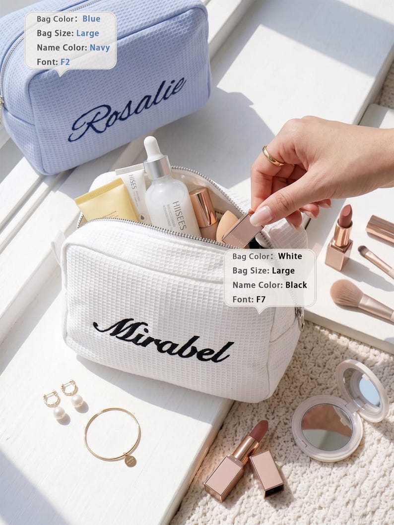 May include: A large white waffle-textured cosmetic bag with the name Mirabel embroidered in black, and a large blue waffle-textured cosmetic bag with the name Rosalie embroidered in navy. The white bag is open, containing various skincare bottles.