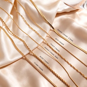 May include: A collection of gold-toned metal chains labelled as follows: a 3.3mm snake chain, a box chain, a twist chain, a 1mm snake chain, a rope chain, and a curb chain. Each chain features a distinct link pattern and metallic finish.