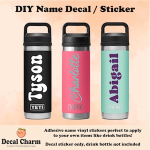 May include: Three YETI brand water bottles with custom vinyl decals featuring the names Tyson, Charlotte, and Abigail. The decals are in various colours and fonts.