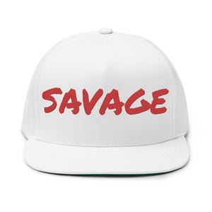 May include: White flat brimmed baseball cap with red embroidered text that says "SAVAGE".