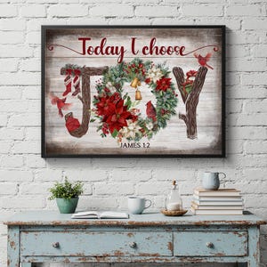May include: Framed artwork with the word "JOY" formed by a decorative wreath and tree branches. The text "Today I choose" is above, and "JAMES 1:2" is below. The wreath features red poinsettias, white flowers, and gold bells.