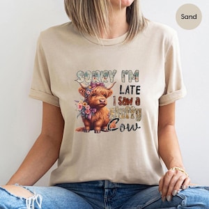 Sorry I’m Late I Saw a Fluffy Cow Shirt – Cute Highland Cow Graphic Tee – Funny Cow Lover T-Shirt – Animal Enthusiast Gift – Sand Color
