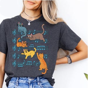 Funny Musical Cat Shirt – Colorful Cats on Sheet Music Tee – Cute Cat Music Lover Gift – Whimsical Kitty Graphic T-Shirt for Musicians