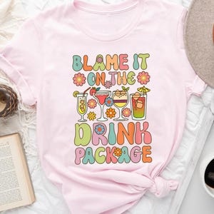 Blame It On The Drink Package Shirt | Funny Cruise Vacation Shirt for Women | Boozy Cocktail Graphic Tee | Beach Party Cruise Humor Shirt
