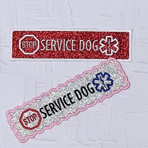 May include: Two rectangular patches with glittery surfaces. The top patch is red with white text reading STOP SERVICE DOG and a white medical symbol. The bottom patch is silver with a pink scalloped border, black text, and a blue medical symbol.
