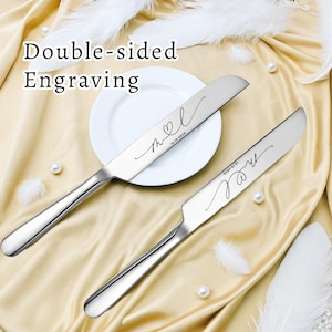 May include: Two silver-toned metal cake knives featuring double-sided engraving with the cursive letters m and l, a heart symbol, and the date 16.10.2030. The text Double-sided Engraving is visible in the upper left corner of the image.