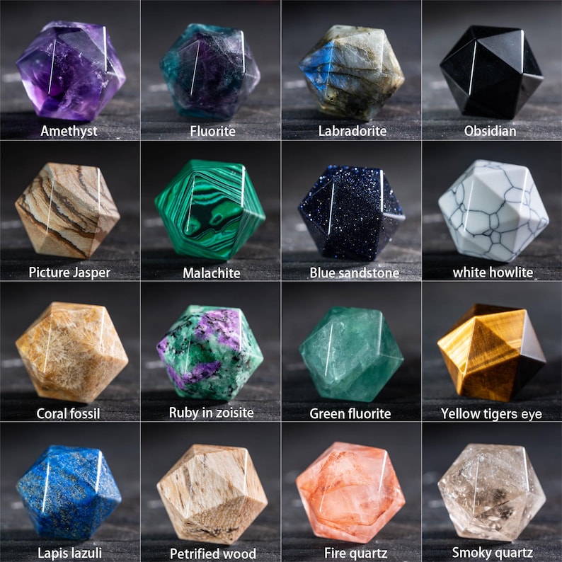 May include: A collection of sixteen faceted gemstone crystals, each with a unique color and pattern. The gemstones include amethyst, fluorite, labradorite, obsidian, picture jasper, malachite, blue sandstone, white howlite, coral fossil, ruby in zoisite, green fluorite, yellow tigers eye, lapis lazuli, petrified wood, fire quartz, and smoky quartz.