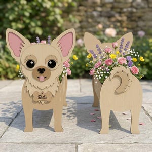May include: Two wooden Chihuahua dog planters, one facing forward and one from the rear. The planters are filled with colorful flowers. The front-facing dog has the name "Bella" on a tag. The dogs are made of light brown wood with pink accents.