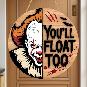 May include: Round wooden Halloween sign featuring a half-face image of a clown with orange hair and red accents. The sign reads "You'll Float Too" in black lettering, with red claw marks and blood splatter details. Includes a jute rope for hanging.