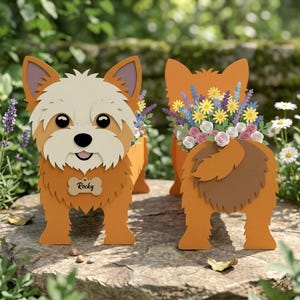 May include: Two orange and white dog-shaped planters, one with a name tag that reads "Rocky." The planters are filled with colorful paper flowers. The planters are made of layered paper.