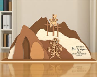 May include: A wooden Easter scene featuring a mountain with three crosses, a tomb, and a floral arrangement. The text "He is risen" is displayed on the base. The color palette includes shades of brown, beige, and cream.