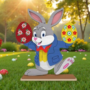 May include: A wooden Easter bunny figure with a blue jacket and red bow tie, holding two decorated Easter eggs. The eggs are red and yellow with floral patterns. The figure is on a brown base, set in a grassy yard with Easter eggs.