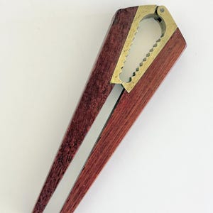 May include: A white ceramic mug with a black handle and the text "But First, Coffee" in a bold, black font. The mug is sitting on a wooden surface. The mug is approximately 4 inches tall.