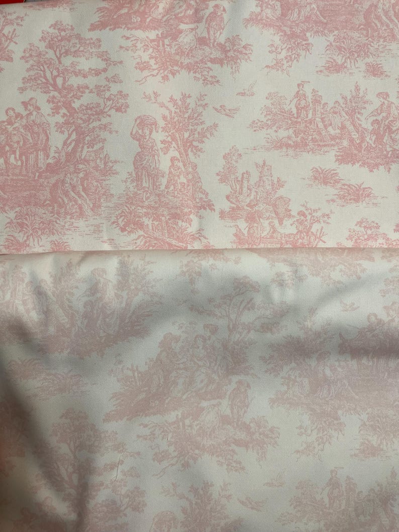 May include: Pink and white toile fabric featuring a pastoral scene with figures, trees, and architectural elements. The fabric has a detailed, repeating pattern, suitable for various sewing and crafting projects.