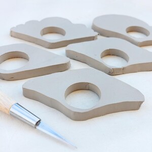 Beginner ceramics project smoothing book page holder edges, DIY pottery with printable template