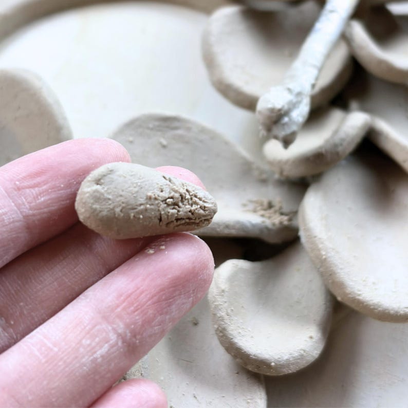 Close-up of forming a single clay leaf for a handmade ceramics wreath, showing air dry clay texture and careful handbuilding process.