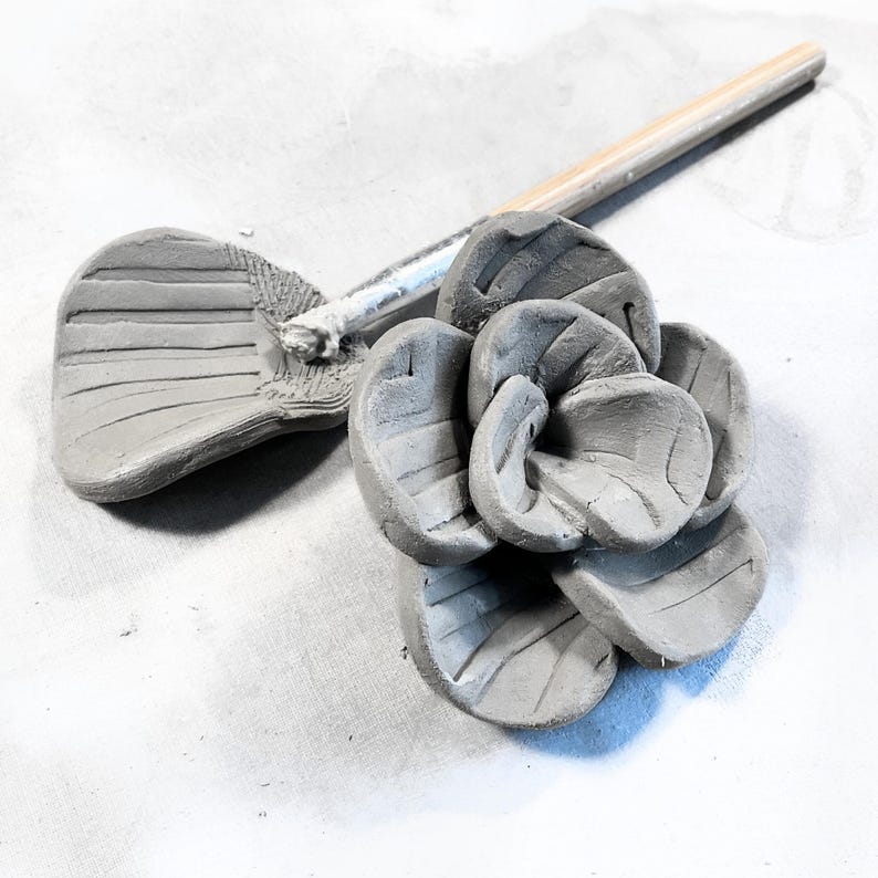 A handmade clay succulent flower in the making formed from pottery templates, turning simple clay flowers into finished handmade pottery decor pieces.