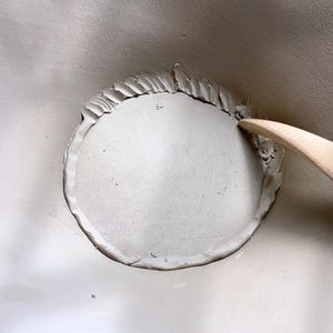 Process view of bottom of handbuilt bowl, slab seam details, and rustic finish for authentic handmade ceramics.