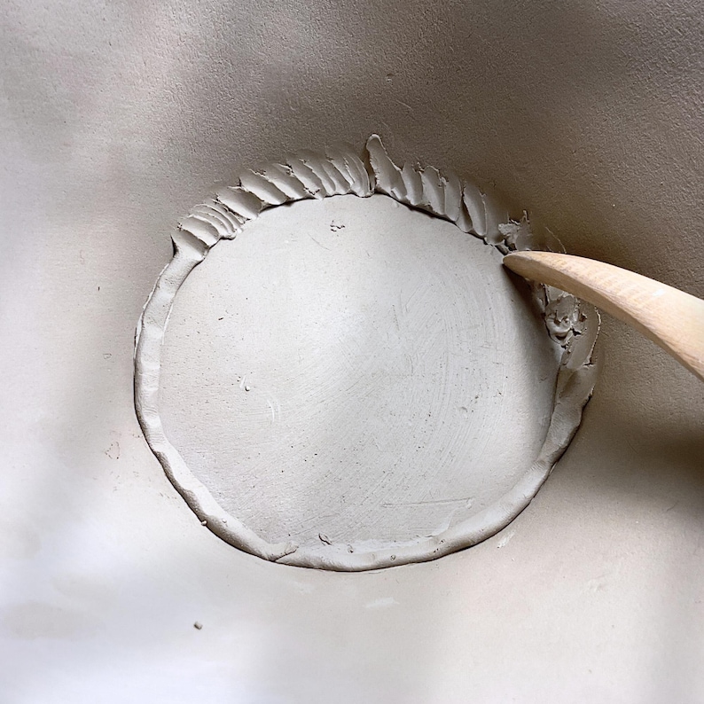 Process view of bottom of handbuilt bowl, slab seam details, and rustic finish for authentic handmade ceramics.