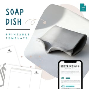 Peut inclure: Un porte-savon gris avec un design incurvé, présenté sur une surface blanche. L'image comprend le texte "SOAP DISH PRINTABLE TEMPLATE" et un smartphone affichant "INSTRUCTIONS STEP BY STEP". Une icône PDF est également visible.