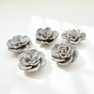Set of five handmade clay flowers created from a succulent flower template, ideal for air dry clay projects, handmade pottery and ceramic template lovers.
