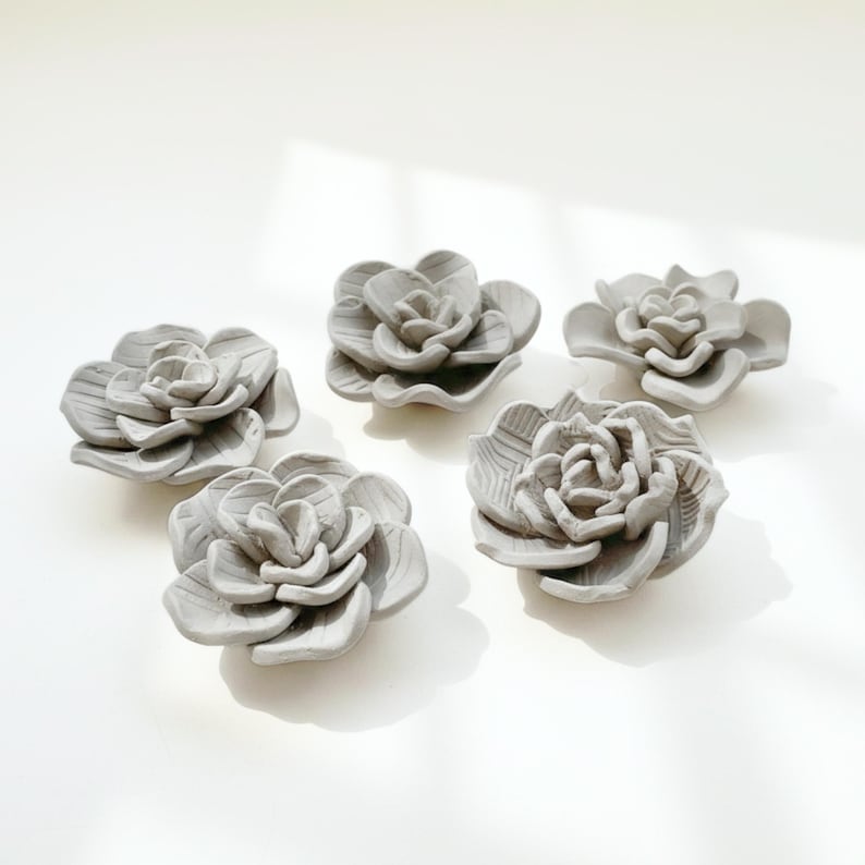 Set of five handmade clay flowers created from a succulent flower template, ideal for air dry clay projects, handmade pottery and ceramic template lovers.