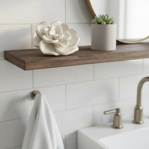 Decorative ceramic succulent flower displayed on a bathroom shelf, made from a clay flower template and styled as a low light plant alternative.