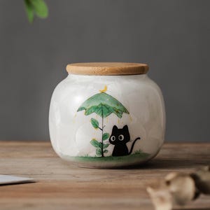 Ręcznie malowana, czarna kotka pod zielonym parasolem, kryształowa ceramiczna urna dla zwierząt z grawerowaną datą, spersonalizowana