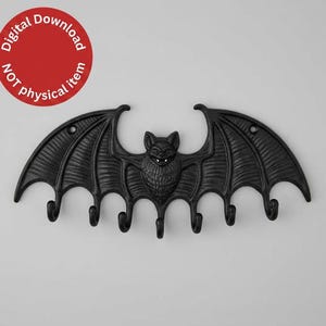 May include: A black wall-mounted hook rack shaped like a bat with spread wings. The bat features detailed fur texture and pointed ears. Six downward-curving hooks extend from the bottom edge of the wings. A red circular badge reads Digital Download NOT physical item.