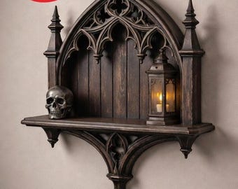 May include: A dark brown gothic-style wall shelf with intricate arch details. It features a small skull, a lantern with a lit candle, and a decorative design. The shelf is made of wood and has a distressed finish.