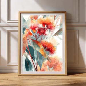 May include: A framed watercolour print featuring red and orange flowers with green and orange leaves. The artwork is set in a light brown wooden frame. The floral art print is displayed on a wooden floor.