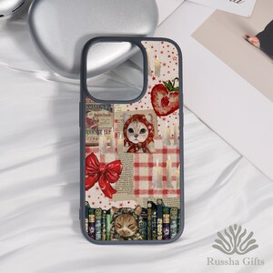 May include: A phone case with a whimsical design featuring a cat wearing a red hood, a red bow, and a strawberry. The background includes candles, stars, and a red and white checkered pattern. The case has a dark blue border.