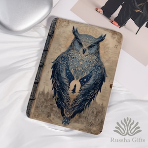 May include: A tablet case featuring a detailed illustration of a blue owl with a starry night design. The owl is set against a vintage-style background with a cityscape at the bottom. The case has a book-like appearance.