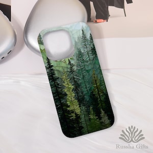 May include: A phone case featuring a forest scene with tall, green trees. The design has a mosaic or stained-glass effect, with varying shades of green and a hint of blue at the top. The case is shown on a white surface.