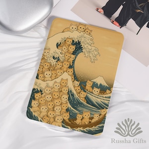 Könnte beinhalten: Ein rechteckiger, hellbrauner Dekorationsartikel mit einer skurrilen Illustration von Katzen in einer Welle, die an Hokusais "Die große Welle vor Kanagawa" erinnert. Das Bild zeigt ein Boot mit Katzen und einen Berg im Hintergrund.