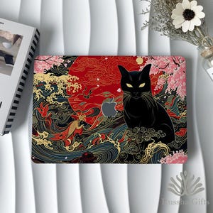 May include: A laptop skin featuring a black cat with yellow eyes centered against a large red sun. The design includes stylized blue ocean waves, gold accents, and pink cherry blossom branches. An Apple logo cutout is visible on the cat's chest.