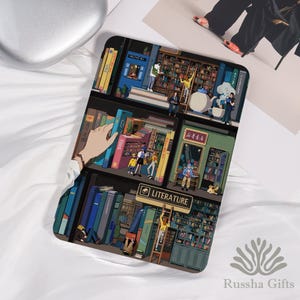 May include: A phone case featuring a detailed illustration of a library scene. The design includes bookshelves filled with colorful books, people, and the word "LITERATURE" on a sign. The case has a glossy finish.