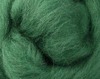 May include: Close-up of a mass of emerald green wool roving. The fibers are soft and fluffy, with a slightly textured appearance. This wool is likely used for needle felting, wet felting, or spinning projects.