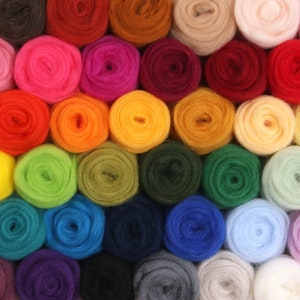 May include: A grid of colorful wool roving in various shades, including red, orange, yellow, green, blue, and purple. The wool is tightly wound into small, round bundles, creating a textured and vibrant display. Ideal for fiber art and crafting projects.